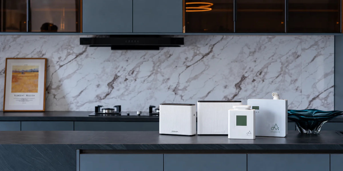 Aromadd HVAC scent diffusers displayed on a modern kitchen counter