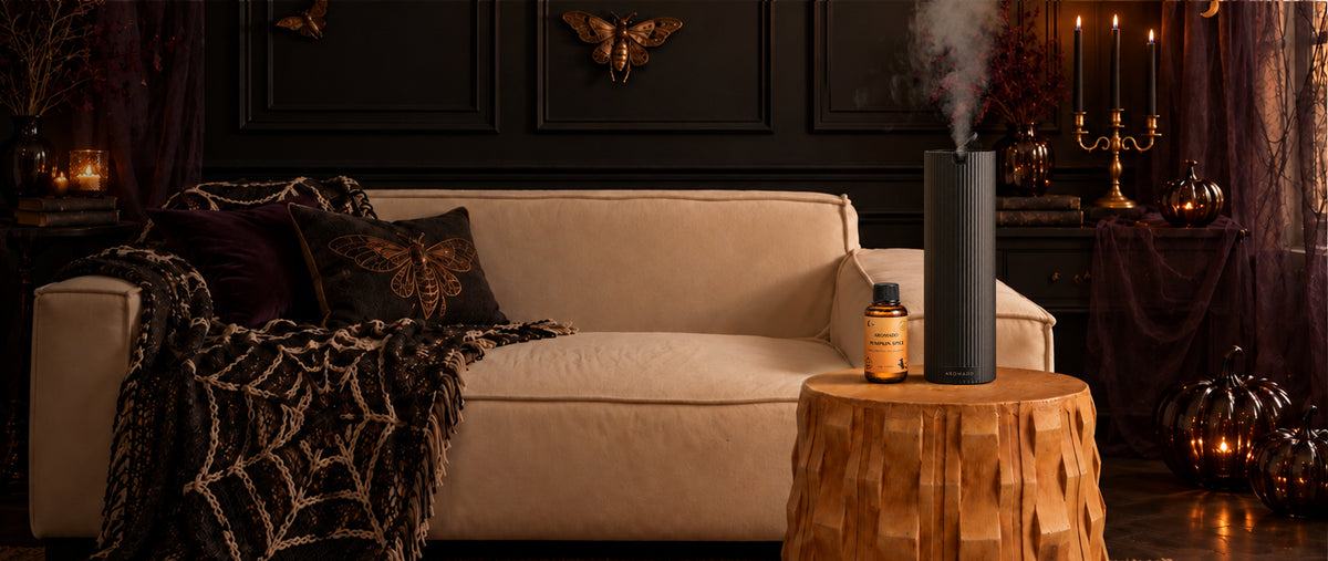 Aromadd tower scent diffuser with Pumpkin Spice fragrance oil in a candlelit Halloween living room.
